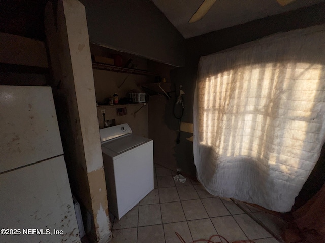 washroom with washer / dryer and light tile patterned floors