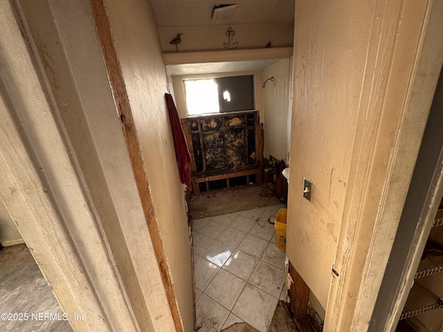 hall featuring tile patterned flooring