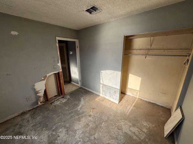 unfurnished bedroom featuring a closet and a textured ceiling