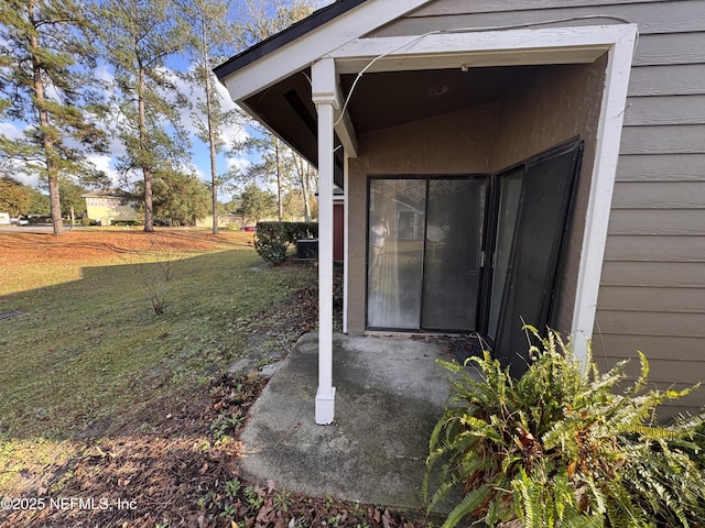 doorway to property featuring a lawn