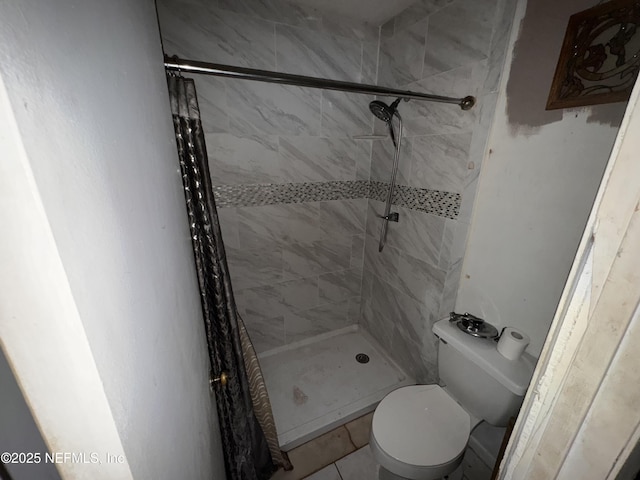 bathroom with a shower with curtain and toilet