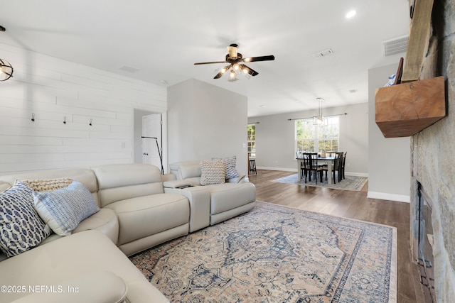 living room with dark wood-type flooring and ceiling fan