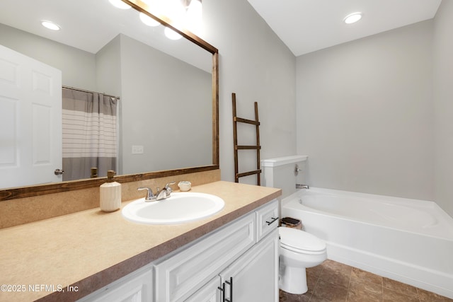 bathroom featuring vanity, toilet, and a tub