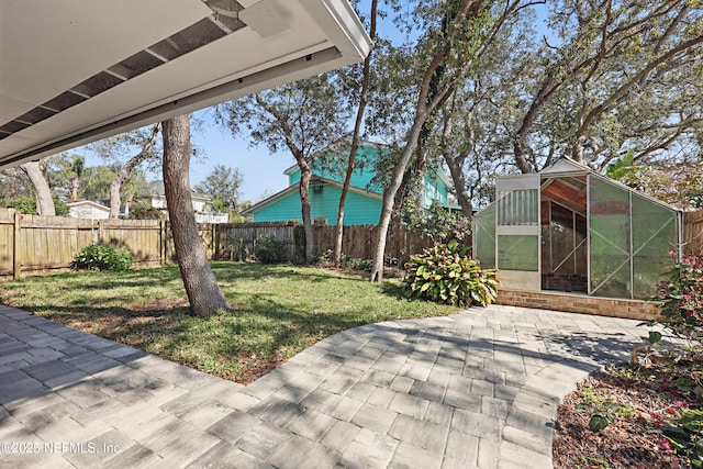 view of yard with an outbuilding and a patio