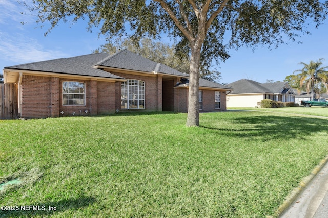 single story home featuring a front lawn