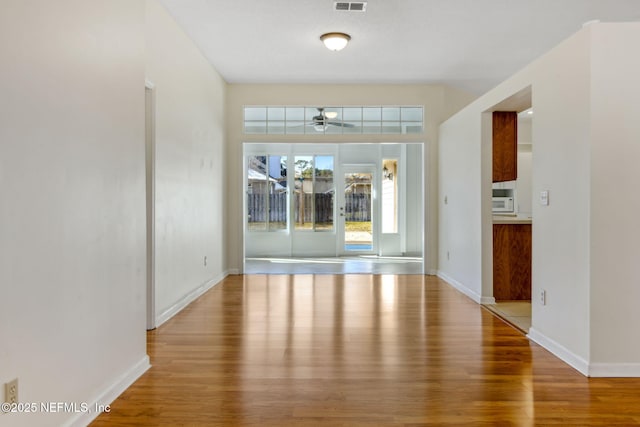 unfurnished room featuring ceiling fan and wood-type flooring