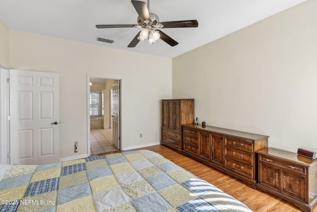 bedroom with ensuite bathroom, ceiling fan, and light wood-type flooring