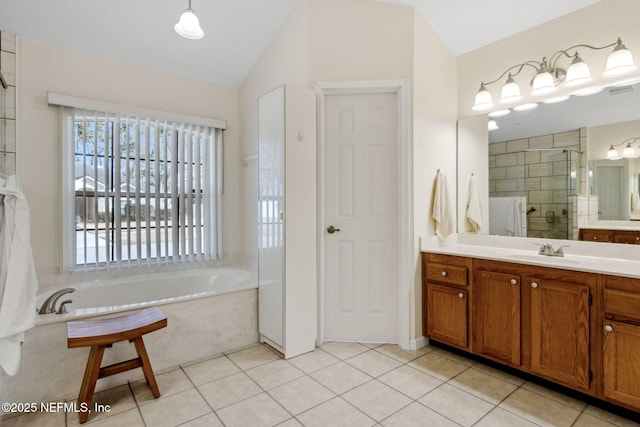 bathroom with lofted ceiling, independent shower and bath, tile patterned flooring, and vanity