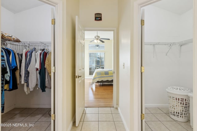 walk in closet with light tile patterned flooring