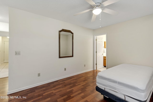 bedroom featuring ceiling fan, wood-type flooring, and ensuite bathroom