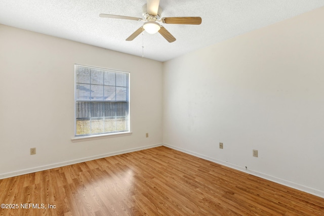 spare room featuring ceiling fan, hardwood / wood-style floors, and a textured ceiling