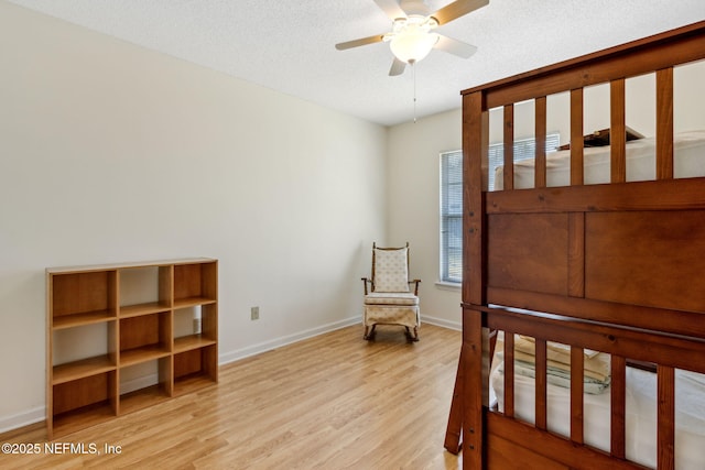 bedroom with light hardwood / wood-style flooring and a textured ceiling