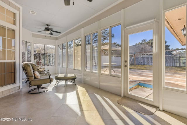 sunroom featuring ceiling fan