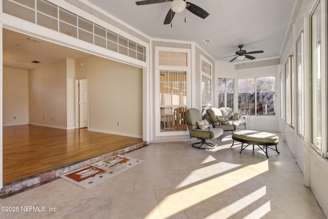 sunroom / solarium featuring ceiling fan