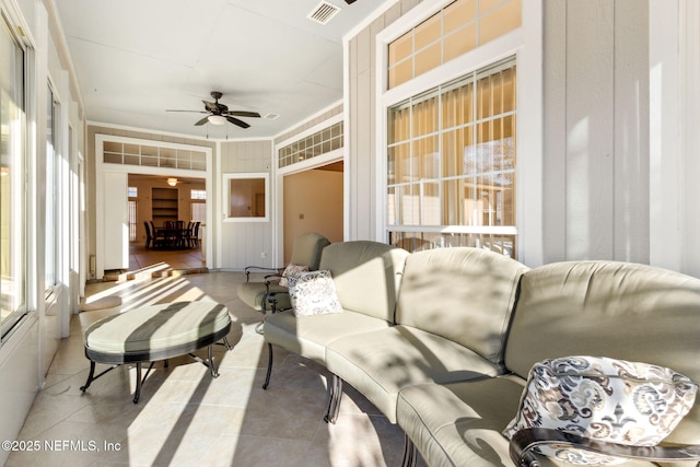 sunroom featuring plenty of natural light and ceiling fan