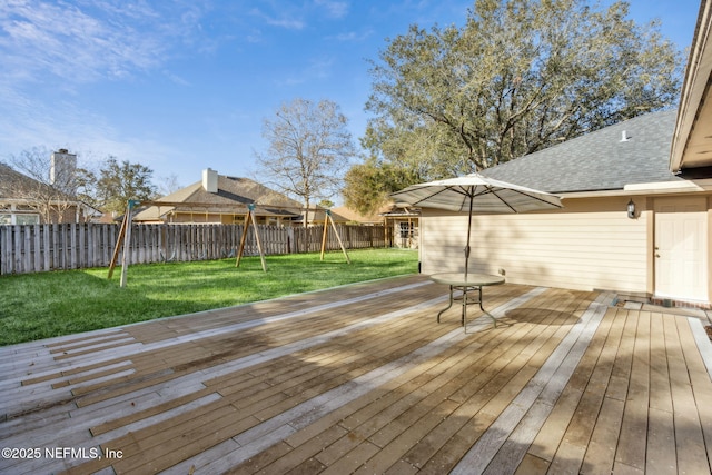 wooden deck featuring a yard