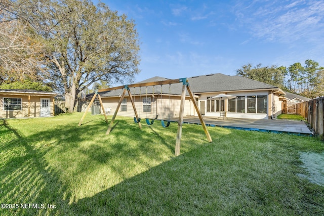 back of house featuring a yard and a deck