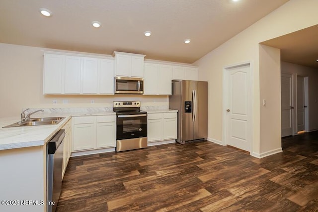 kitchen featuring sink, vaulted ceiling, white cabinets, and appliances with stainless steel finishes