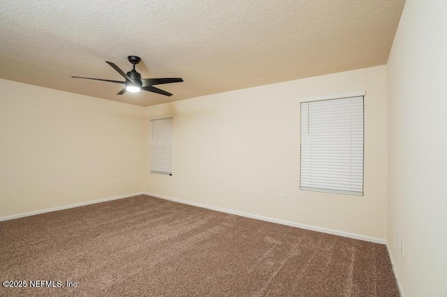 empty room featuring ceiling fan, a textured ceiling, and carpet