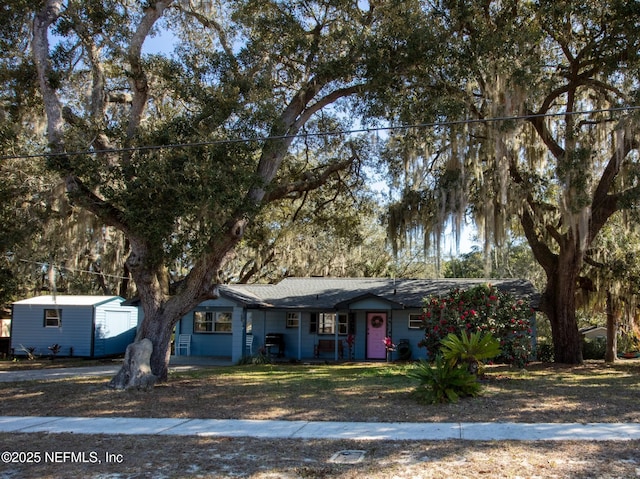 view of front of home featuring a garage and an outdoor structure