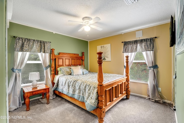 carpeted bedroom with multiple windows, a textured ceiling, and ceiling fan