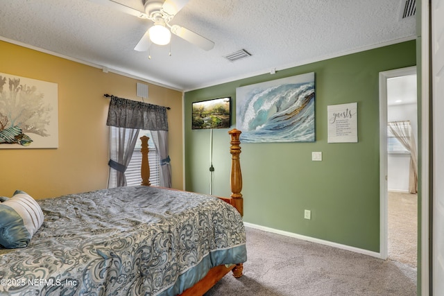 carpeted bedroom featuring a textured ceiling, ornamental molding, and ceiling fan