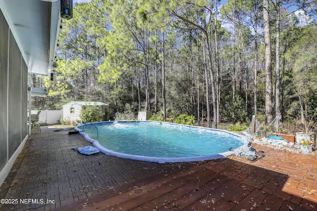 view of pool with a shed