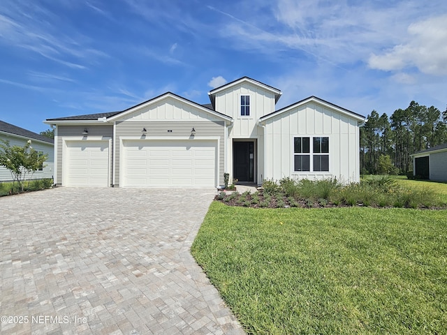 101 Erlking Ct, Saint Johns, FL 32259 - view of front of property featuring board and batten siding, decorative driveway, a garage, and a front lawn