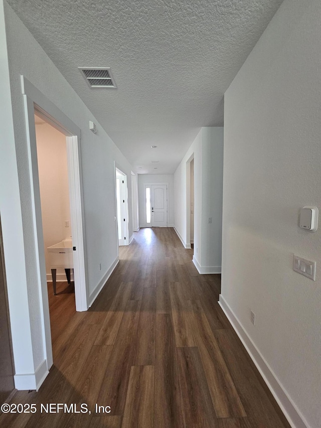 101 Erlking Ct, Saint Johns, FL 32259 - hall with dark wood-type flooring and a textured ceiling