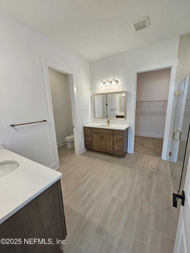 101 Erlking Ct, Saint Johns, FL 32259 - full bathroom featuring vanity, a shower stall, wood finished floors, and a spacious closet