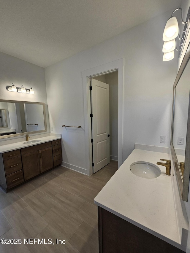 101 Erlking Ct, Saint Johns, FL 32259 - bathroom featuring two vanities and baseboards
