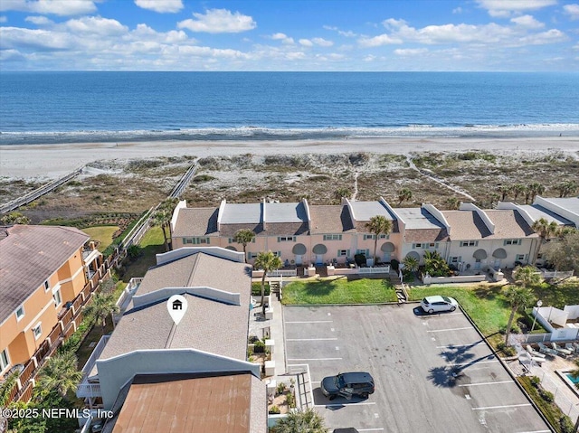 birds eye view of property with a water view and a view of the beach