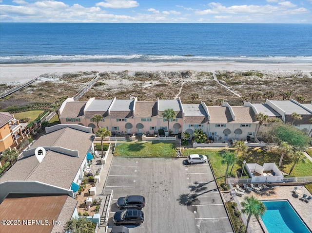 bird's eye view featuring a view of the beach and a water view