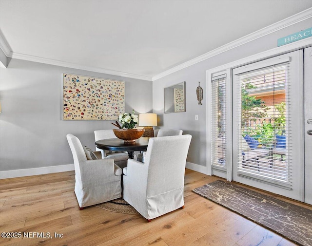 dining space with crown molding and wood-type flooring