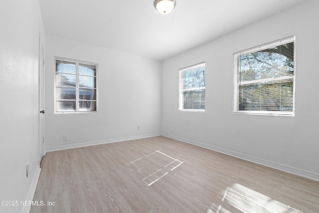 unfurnished room with light hardwood / wood-style floors