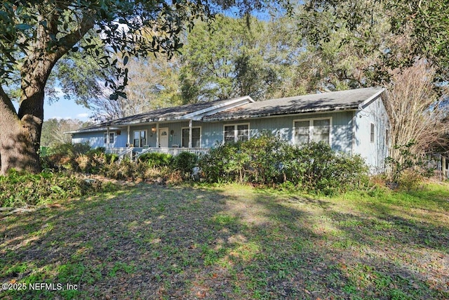 ranch-style home with covered porch and a front yard