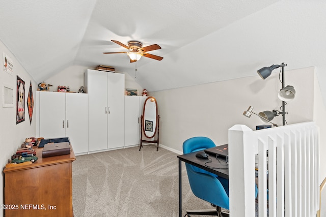 bedroom with ceiling fan, lofted ceiling, light colored carpet, and a textured ceiling