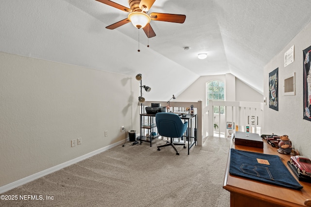 carpeted home office with vaulted ceiling and a textured ceiling