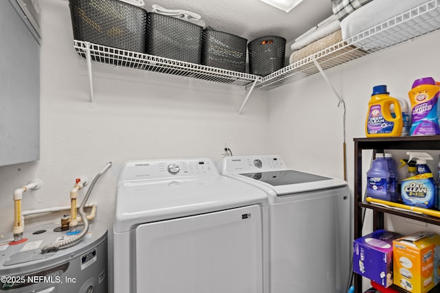 clothes washing area with water heater and washer and dryer