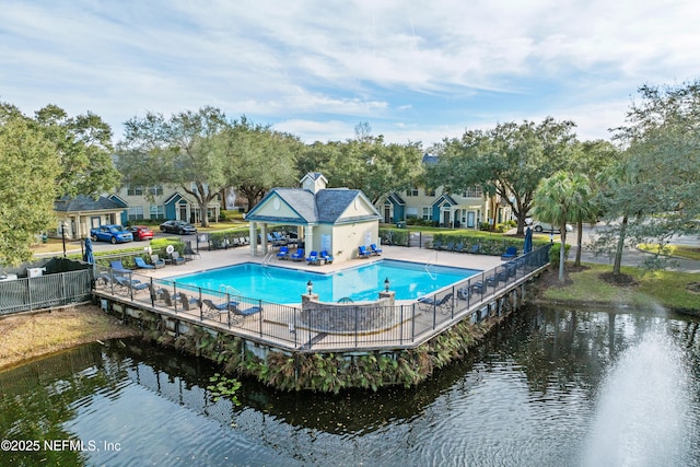 view of swimming pool featuring a water view