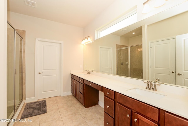 bathroom with tile patterned flooring, vanity, and an enclosed shower