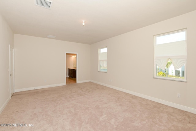 empty room featuring light colored carpet