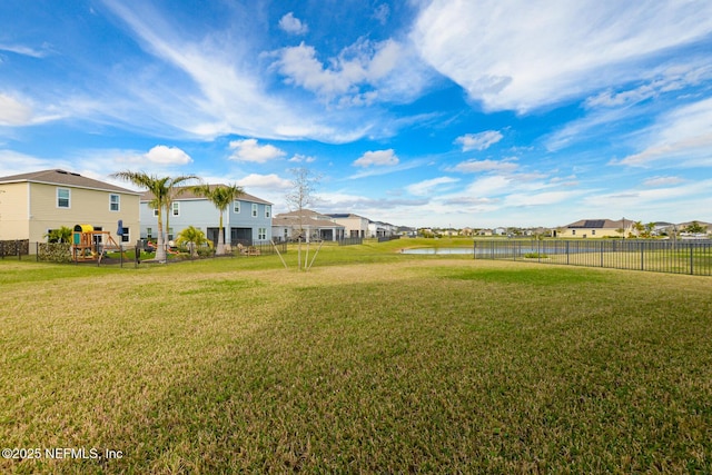 view of yard with a playground and a water view