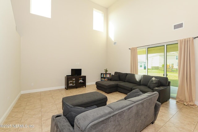 tiled living room with a towering ceiling