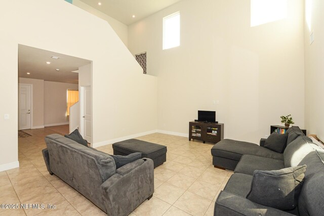 living room featuring a high ceiling and light tile patterned floors