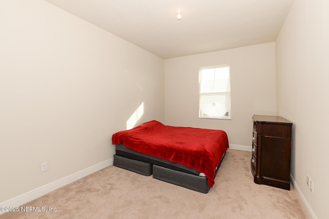 bedroom with light colored carpet