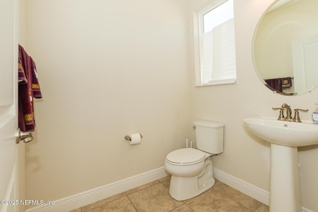 bathroom with tile patterned flooring, sink, and toilet