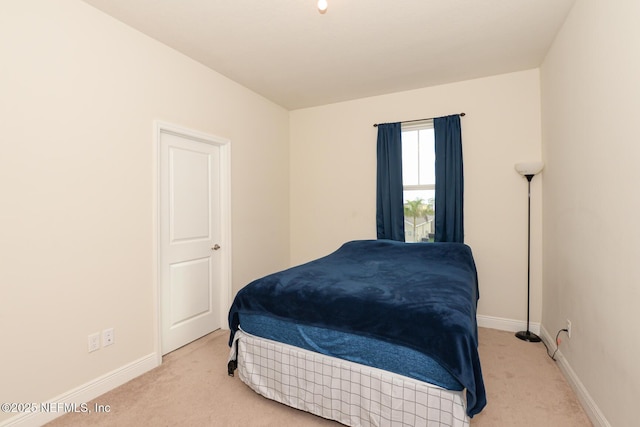 bedroom with light colored carpet