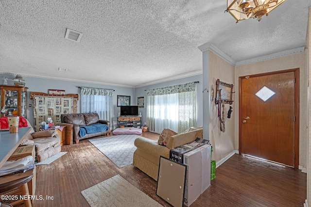 living room with dark wood-type flooring, ornamental molding, and a textured ceiling