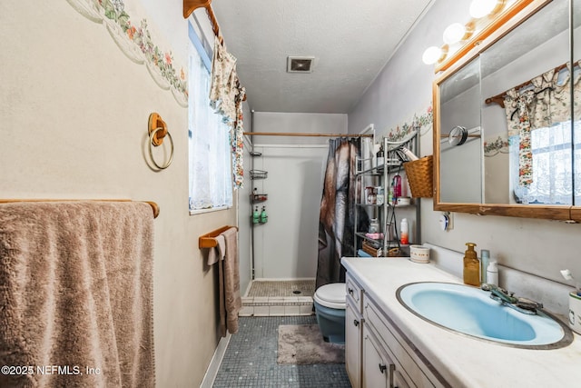 bathroom with walk in shower, tile patterned floors, toilet, a textured ceiling, and vanity